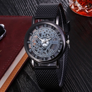 Detail of all-black skeleton watch dial with Roman numerals on a dark executive desk