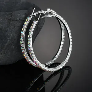 Detail of silver hoop earrings featuring iridescent AB crystals and a mirror reflection