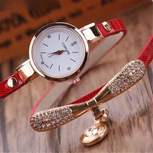 Macro detail of rose gold quartz watch with red wrap leather strap and diamond accents