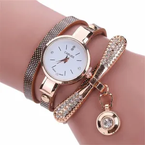 Detail of rose gold multi-strand bracelet watch with rhinestones and round dial charm