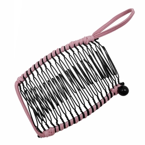 Detailed view of pink and black woven banana hair clip with elastic cord and side bead
