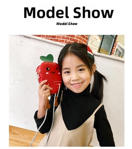 Cute red carrot-shaped kids crossbody bag with green leaf detail and white woven strap