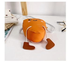 Detail view of mini carrot shoulder bag with cute cartoon face and decorative legs