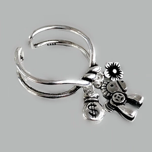 Detail of silver charm ring featuring horse, money bag and flower pendants