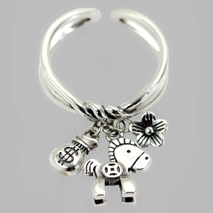 Detailed macro view of silver ring with lucky money bag, horse, and flower charms
