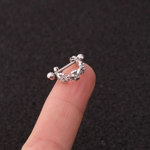 U-shaped stainless steel ear stud featuring zircon flowers shown on a fingertip