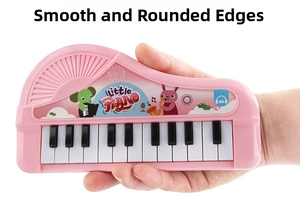 Detail of pink cartoon electronic piano showing smooth rounded edges for safe child play