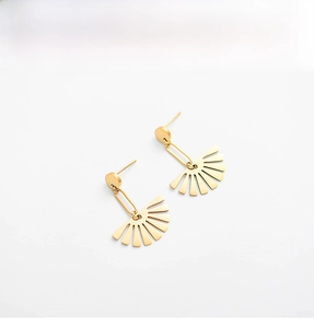 Detailed view of 18K gold plated fan shaped stainless steel earrings on a white surface