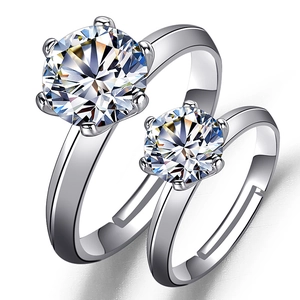 Detailed view of two classic six-prong silver rings with brilliant round cut stones