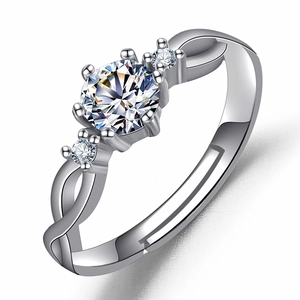 Macro shot of silver six-prong ring with round zircon and twisted adjustable band