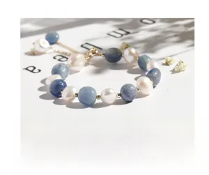 Detail of handmade bracelet with blue aventurine beads, pearls and golden chain
