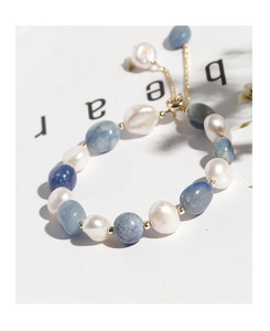 Detail of blue aventurine and irregular pearl bracelet with adjustable gold toggle clasp