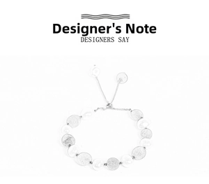 Detail of adjustable silver bracelet featuring brushed metal discs and drawstring slider