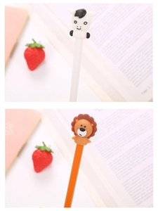 Close-up of cute cartoon lion and cow pen caps on student stationery writing pens
