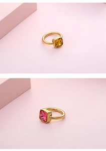 Detail of titanium steel ring with large square yellow and rose red zircon stones