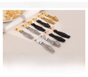 Detail showing mesh chain heart tassel earrings in gold, silver, rose gold and black