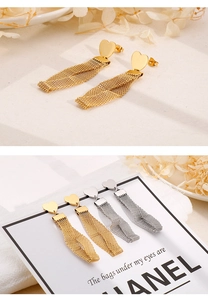 Detailed view of elegant gold and silver heart-shaped stud earrings with mesh chain tassels