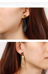 Detailed view of heart stud earrings with metallic mesh tassels in gold and black finish