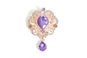 Detailed macro view of baroque water drop crystal brooch with purple rhinestones