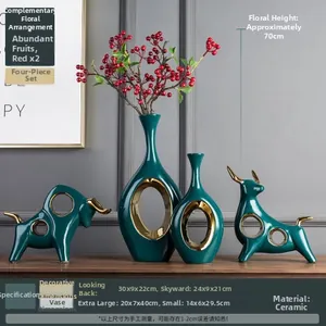 Detailed view of dark green ceramic vases and bull sculptures with gold trim accents