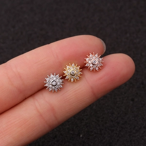 Three sunburst zircon stud earrings in silver gold and rose gold finish on fingers