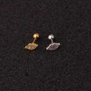 Detailed view of gold and silver lip-shaped stud earrings with sparkling cubic zirconia