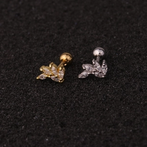 Detail of gold and silver leaf earrings with marquise cubic zirconia and screw ball backs