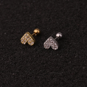 Close-up of gold and silver heart screw-back stud earrings with sparkling zircon pave