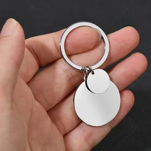 Detailed view of dual round stainless steel pendant keychains with a polished silver finish