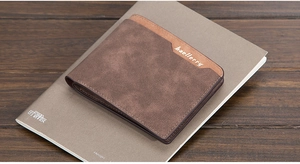 Close-up of a slim dark brown PU leather wallet with bifold design on a wooden table