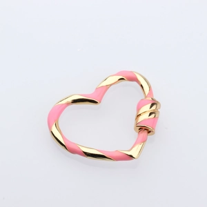 Detailed macro view of heart-shaped twisted link connector in pink and gold enamel finish