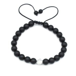 Detail of 8mm matte black beads and white marble stone on adjustable braided rope bracelet