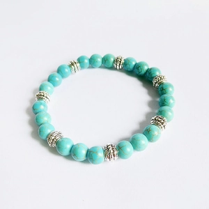 Macro shot of 8mm turquoise style beads with vintage engraved silver metal spacers