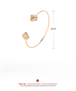 Detail view of gold triangle open bangle showing copper material, 6cm size and 3.52g weight