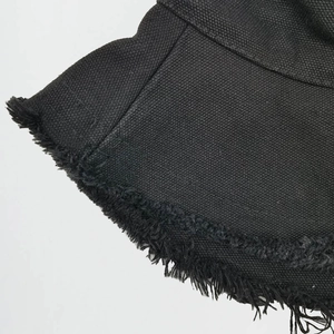 Classic black bucket hat in distressed canvas with frayed edges and structured brim