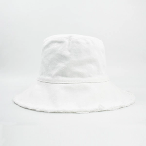 Close-up of raw fringe edge and textured cotton canvas on a white bucket sun hat
