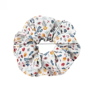 Floral print scrunchie showing 12cm diameter and 5cm width measurements in detail