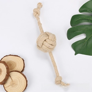 Macro shot of a durable beige woven cotton rope ball toy for dog teething and play