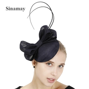 Close-up of Navy Blue Sinamay Fascinator with Large Bow and Delicate Feather Details