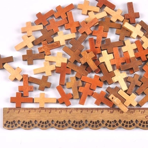 Bulk wooden cross beads in various natural wood tones for DIY jewelry making