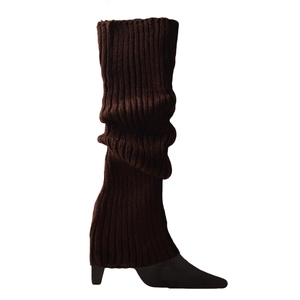 Close-up of dark brown ribbed knit leg warmers showing thick elastic texture and soft folds