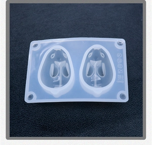 Detail of white silicone rabbit mold showing food-grade mark and heat resistance range