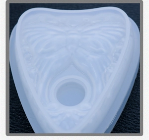 Detailed heart-shaped silicone mold with embossed butterfly wing textures for DIY resin