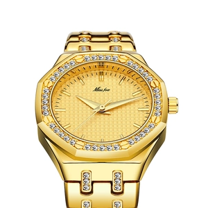 Close-up of golden quartz watch with luxury diamond bezel and grid texture dial face