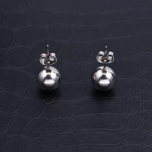 Classic silver stainless steel ball stud earrings with polished mirror finish on black leather