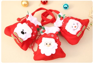 Close-up detail of 3D cartoon Christmas characters on red drawstring candy bags