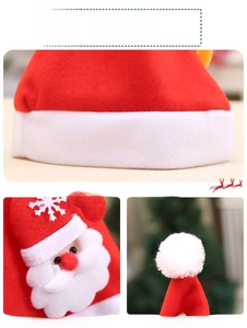 Detailed close-up of velvet Christmas hat fabric with 3D Santa applique and embroidery