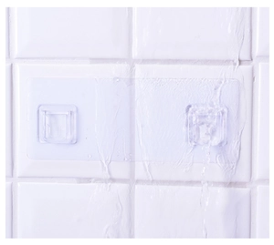 Waterproof transparent double adhesive hooks showing strong grip on wet bathroom tiles