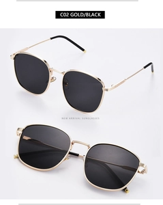 Detail view of square gold metal frames and black lenses of fashionable sunglasses