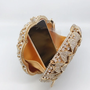 Detail view of champagne gold sunflower evening bag showing smartphone capacity